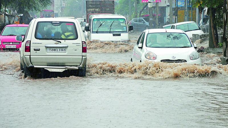 Vehicles plough through the flooded road at Moosarambagh following heavy rain in the city on Wednesday. (Photo: Deepak Deshpande)
