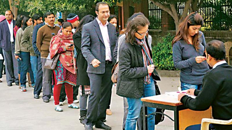 A file photo of parents waiting in a queue at a school for admission forms. (Photo: DC)