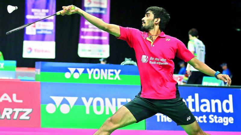 Srikanth Kidambi returns a shot to Lucas Corvee of France during their mens singles second round match at the World Badminton Championships in Glasgow, Scotland, on Wednesday. Srikanth won 21-9, 21-17.