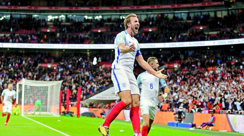 Englands Harry Kane celebrates after scoring the goal during the World Cup qualifying match against Slovenia at Wembley stadium in London. (Photo: AP)