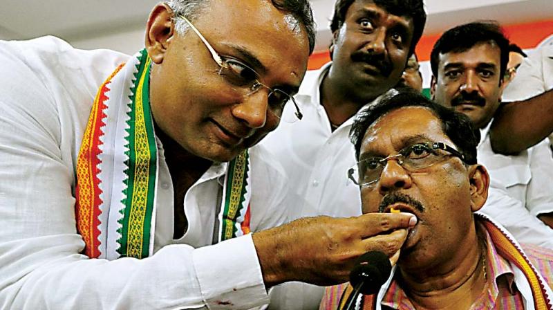 KPCC President Dr G Parameshwar and working president Dinesh Gundurao with Congress workers celebrate the bypoll victory at the KPCC office on Thursday. (Photo: KPN)