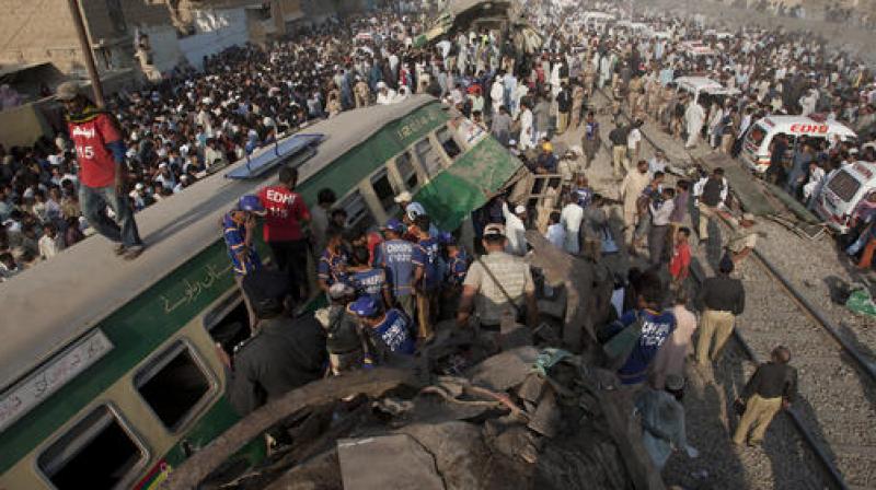 People look for victims in the wreckage of the trains in Karachi, Pakistan. (Photo: AP)