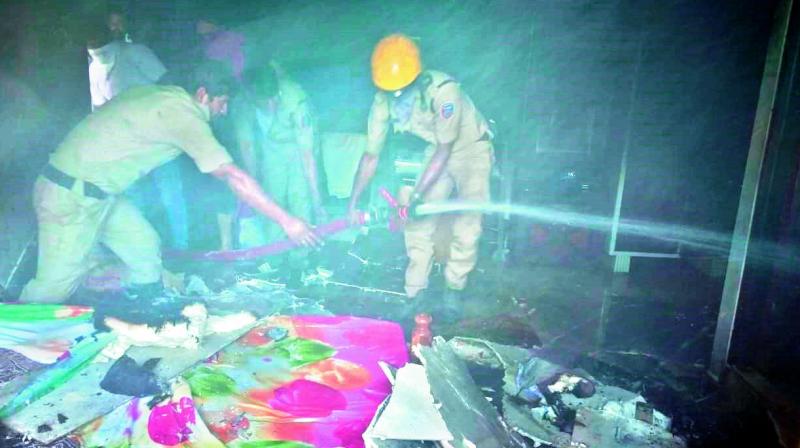 Fire safety officials try to douse fire at an apartment in Dabeerpura Darwaza on Tuesday.