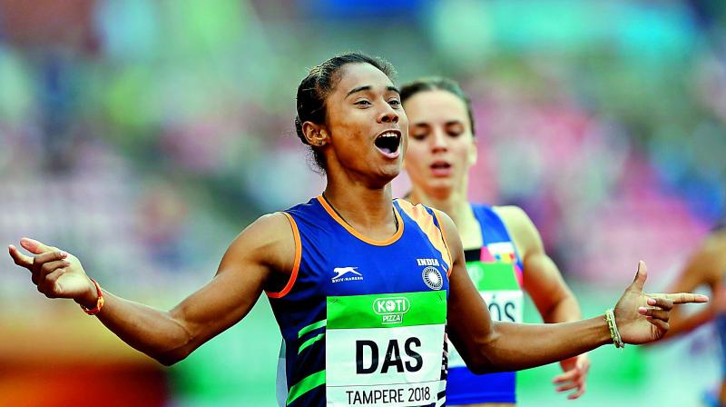 Hima Das celebrates winning the 400m final at the World U-20 event.