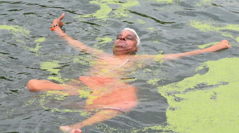 Thrissur: Yoga in weed-covered pond