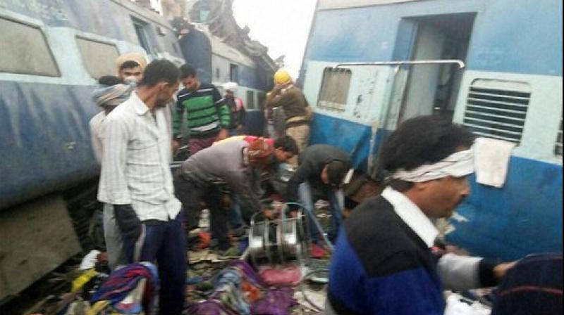 Rescue officials on the spot where 14 coaches of the Indore-Patna express derailed, killing around 90 people and injuring 150, in Kanpur Dehat.