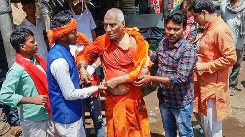 Supporters of Swami Agnivesh said he was dragged on the road, slapped and kicked by BJP workers who had assembled outside his hotel on Tuesday to oppose his presence in the district.  (Photo: PTI)