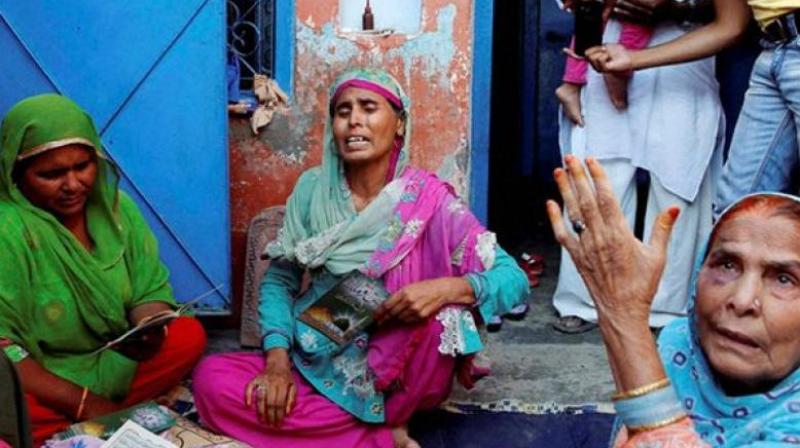 The family of Ikhlaq, who was beaten to death by a mob, at Bishada in Dadri. (Photo: PTI | File)