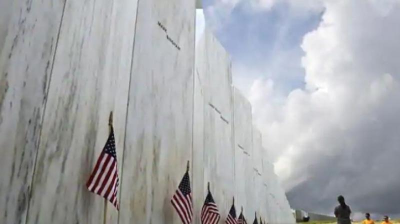 Visitors to the Flight 93 National Memorial pause at the Wall of Names honouring 40 passengers and crew members of United Flight 93 killed when the hijacked jet crashed at the site during the 9/11 terrorist attacks, near Shanksville, Pennsylvania. (Photo: AP)