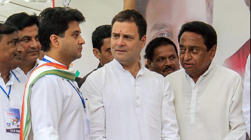 Congress President Rahul Gandhi C Congress leader and MP Jyotiraditya Madhavrao Scindia L and State President Kamal Nath during a roadshow in Bhopl. (Photo|: PTI)