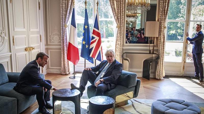 Watch: Boris Johnson puts his feet up at palace during Brexit talks, Macron amused