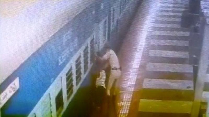 A Railway Protection Force (RPF) constable saved the life of a middle-aged passenger who lost the balance and had fallen between the gap of the platform and moving train while getting down. (Photo: ANI)