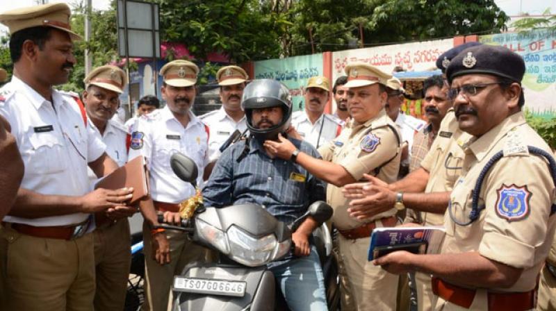 Hyderabad traffic cops award violators with helmets instead of challans