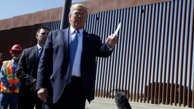 \Fry egg on that wall\: Trump touts design, signs wall during US-Mexico border visit