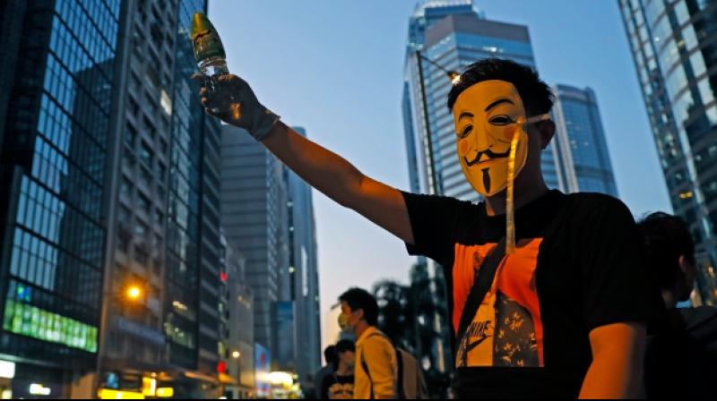 2 protesters charged in first use of Hong Kong\s new mask ban