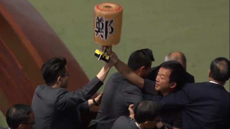 Watch: Hong Kong lawmakers dragged from chamber as leader heckled for second day