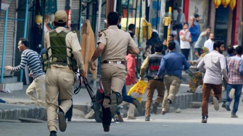 Security personnel chase away agitators during a protest against the police action on protesters in Kupwara, in Srinagar earlier this year. (Photo: PTI)