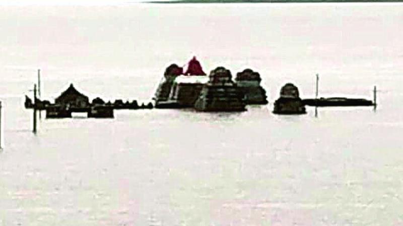 The temples gopuram gets submerged in floodwater at Kothapalli mandal in Kurnool district.  	 DC