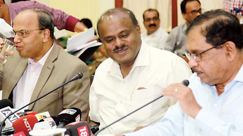 Chief Minister H.D. Kumaraswamy, DyCM G. Parameshwar and Chief Secretary T.M. Vijaya Bhaskar at a function to mark the first anniversary of the coalition government in Bengaluru on Thursday.  (DC)