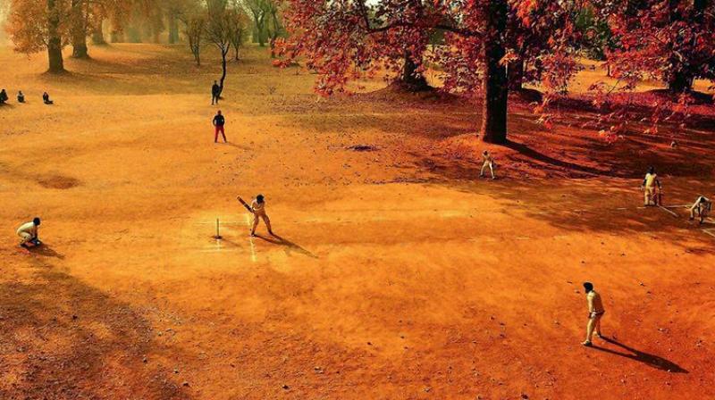 The winning picture of a group of boys playing cricket in Kashmir, clicked by Saqib Majeed.