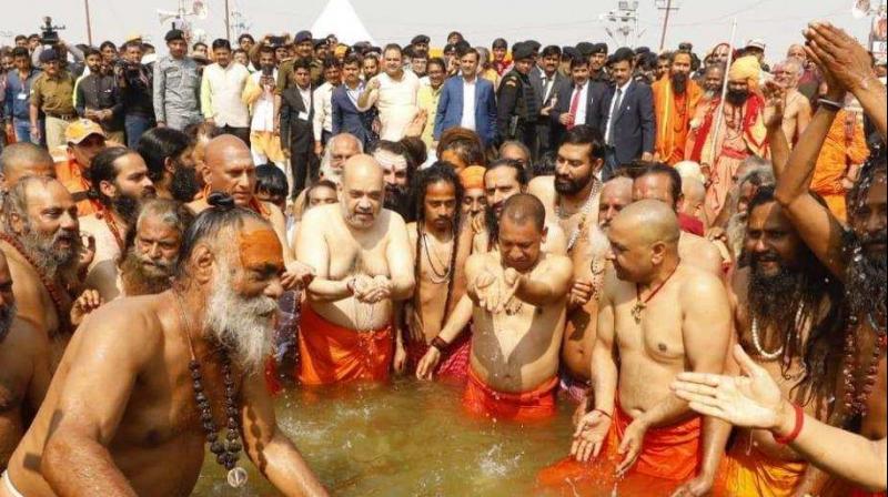 Wearing a saffron dhoti, the leaders of the BJP offered their prayers at Sangam, the holy confluence of the Ganges, Yamuna and the mythical Saraswati. (Photo: Amit Shah | Twitter)