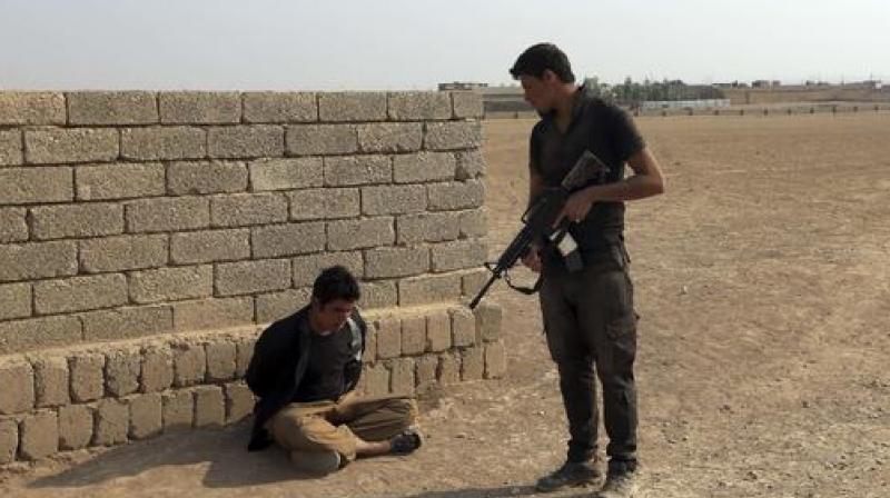 A member of Iraqs elite counterterrorism forces arrests a suspect of Islamic State in the village of Tob Zawa, about 9 kilometers (5Â½ miles) from Mosul, Iraq. (Photo: AP)