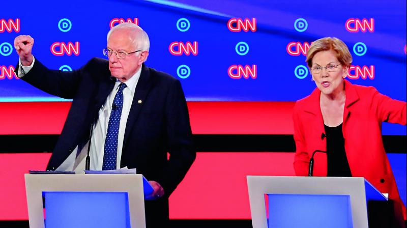 Senators Bernie Sanders and Elizabeth Warren in the first of two Democratic presidential primary debates on Wednesday, in the Fox Theatre in Detroit. 	 AP