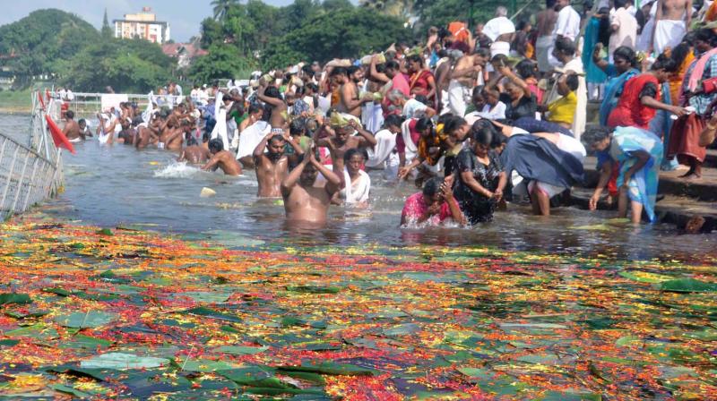 Devotees pay respects to the departed by performing Balitharpanam during Karkidaka Vavu at River Periyar in Aluva on Wednesday