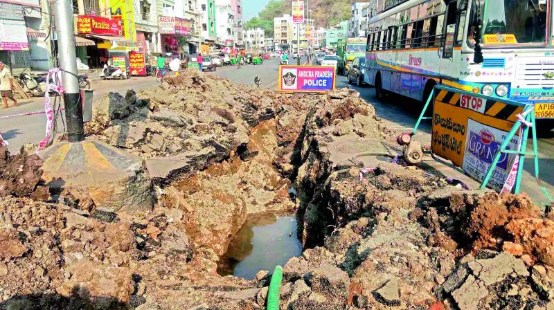The busy Ganapatirao Street in One Town of Vijayawada was eroded on Thursday night leading to traffic jams. 	(Photo:  DECCAN CHRONICLE)