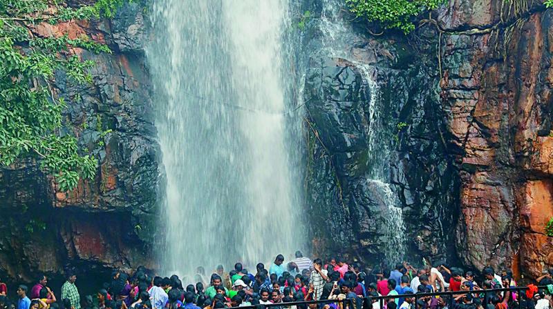 Rainwater gliding from the hill rock at Kapila Teertham in Tirupati, where scores of devotees being delighted with holy bath.