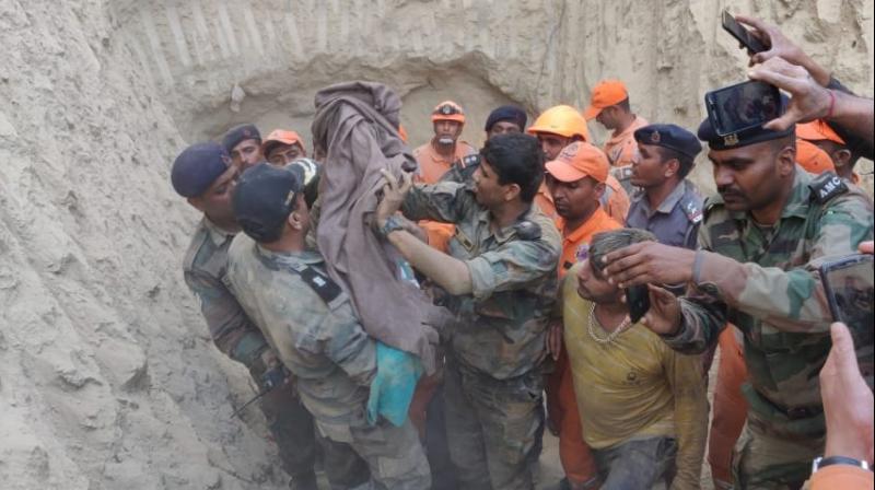 As the rescuers on Friday reached close to the spot where the child was trapped, digging by machines was stopped and was carried out manually to ensure that soil did not fall over the infant, officials said. (Image: ANI)