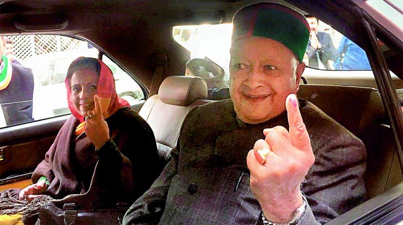 Himachal Pradesh Chief Minister Virbhadra Singh shows his inked finger after casting his vote at a polling both, in Rampur on Thursday. (Photo: PTI)