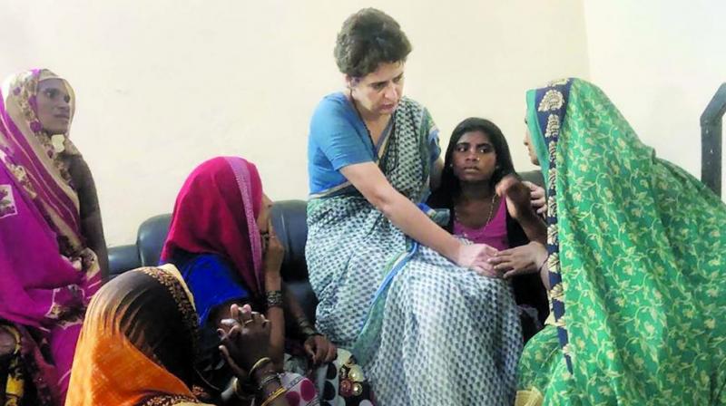 Priyanka Gandhi Vadra with family members of Sonbhadra massacre victims in Mirzapur. (Photo: PTI)