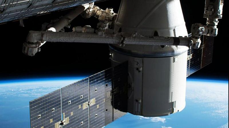In this image provided by NASA, the Dragon capsule arrives at the International Space Station on Wednesday, April 4, 2018 with food and experiments. It will remain attached to the orbiting outpost for about a month, returning to Earth in May. Dragon launched Monday from Cape Canaveral, Florida, aboard a used Falcon rocket. SpaceX wants to reduce launch costs by recycling rocket parts. (Photo: AP)