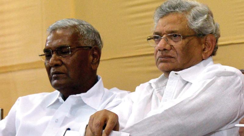 CPM general secretary Sitaram Yechury rolls up his sleeves before his lecture on Challenges posed by communal fascists at a national seminar in Thiruvananthapuram on Friday. CPI leader D. Raja, MP, is also seen.   (Photo: PEETHAMBARAN PAYYERI)
