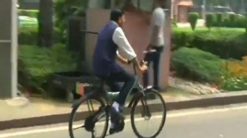 Union Minister Mansukh Mandaviya rides bicycle to Parliament