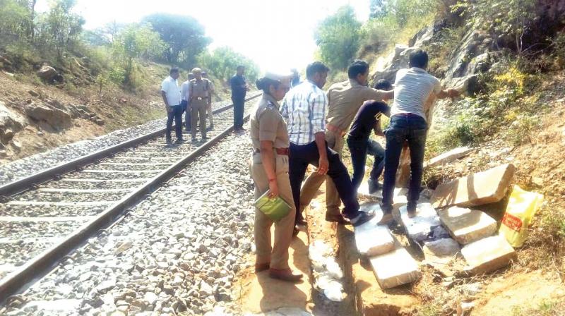 Police conduct probe at the spot where cement slabs placed on the track at Karuvalli village. (Photo: DC)
