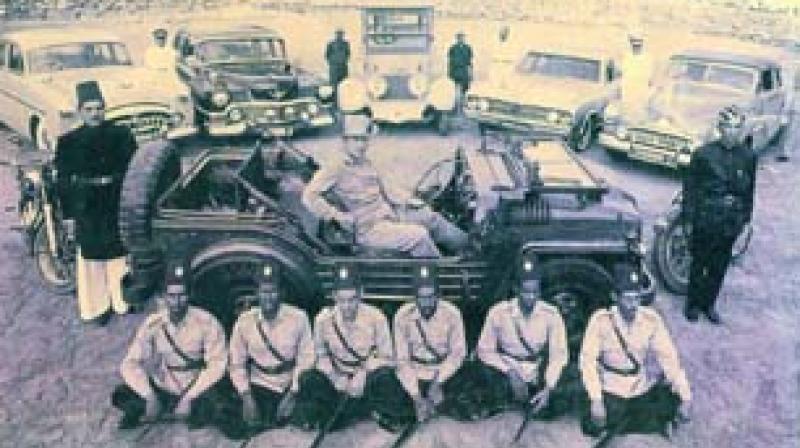 Prince Mukarram Jah with cars and attendants (circa 1965)
