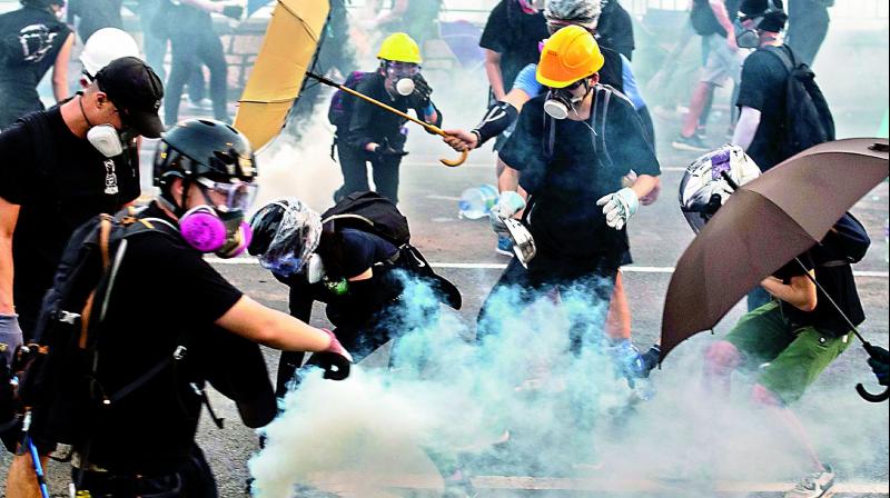 Hong Kong police fire tear gas as general strike paralyses city