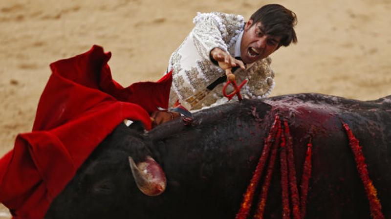 In this photo taken on Monday, June 5, 2017, Spanish bullfighter Noe Gomez del Pilar kills a Dolores Aguirre ranch fighting bull during a bullfight at the Las Ventas bullring in Madrid.