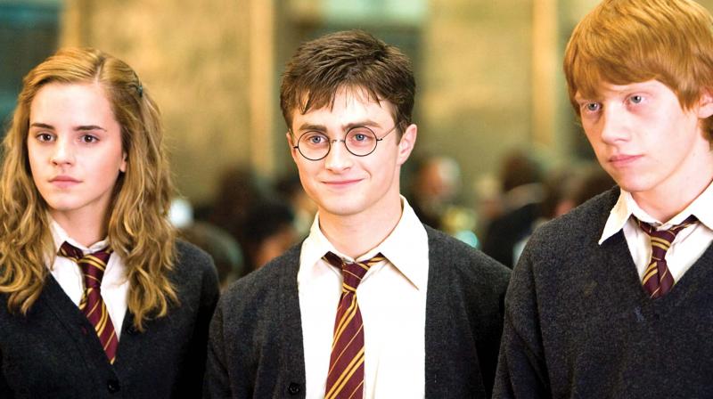 Daniel Radcliffe (centre) as Harry Potter in the movie series.