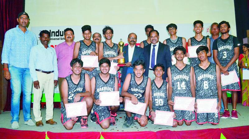 Oakridge International Schools Under-19 basketball players are all smiles as they pose with the CBSE Cluster VII Basketball winners trophy from A. Dinakar Babu, Vice-Chairman & Managing Director of Sports Authority of Telangana State, at the Indus Universal School in Yapral, Secunderabad.