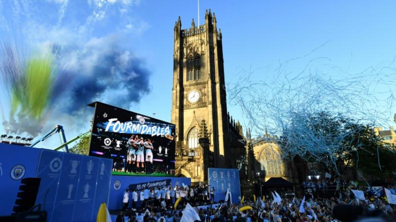 Manchester City celebrates domestic treble with an open-top bus parade