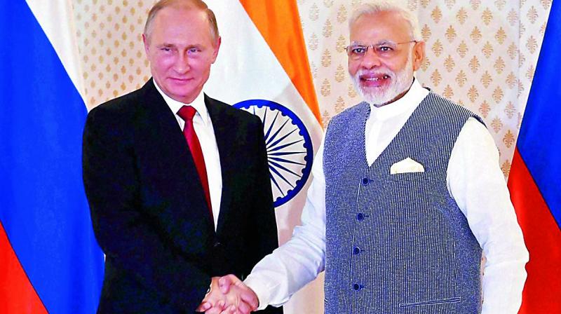 Russian President Vladimir Putin being welcomed by Prime Minister Narendra Modi ahead of the 17th India-Russia annual summit in Benaulim, Goa, on Saturday. 	(Photo: PTI)