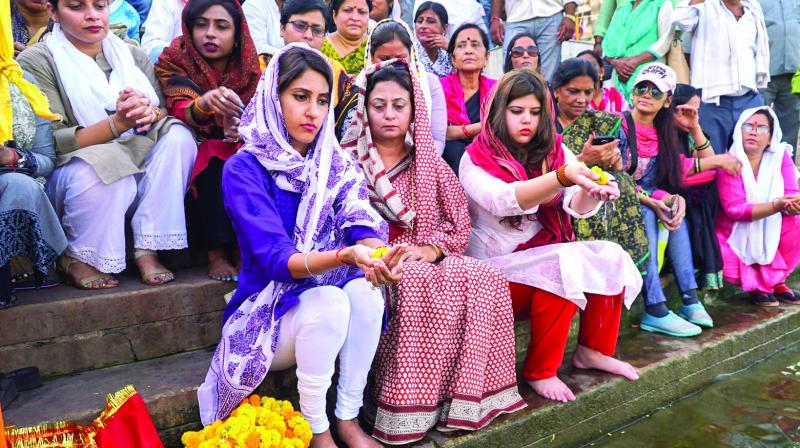 Congress MLA from Rae Bareli Aditi Singh, who was attacked three days ago, offers prayer at Dashashwamedh Ghat in Varanasi on Friday. (Photo: PTI)