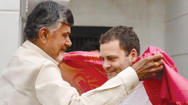 Andhra Pradesh Chief Minister Chandrababu Naidu presents a shawl to Congress president Rahul Gandhi in New Delhi on Thursday. (PTI)