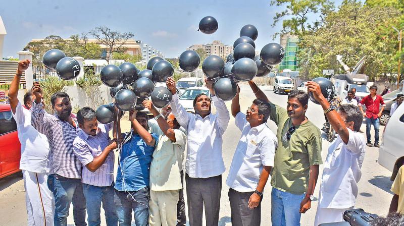 Tamizhaga Vazhvurimai Katchi leader T. Velmurugan and his supporters release black balloons on Monday, as a mark of protest against IPL cricket matches scheduled in Chennai. (Photo: DC)