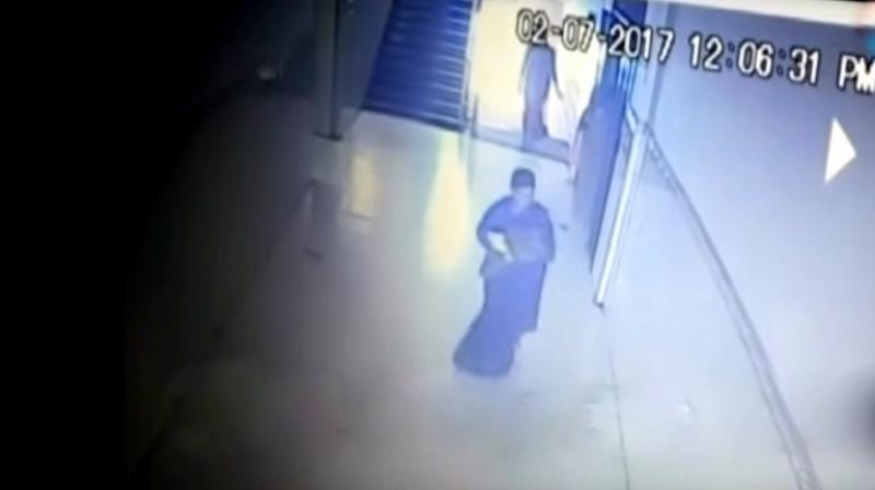 CCTV footage showed a woman carrying the baby from the hospital and heading towards a bus terminal. (Photo: YouTube | Screengrab)