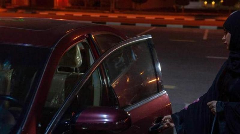 A Saudi woman gets ready to drive her car through the streets of Khobar City on her way to Kingdom of Bahrain. (Representational Image | AFP)