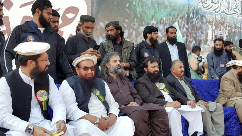 Jamaat-ud-Dawah (JuD) chief and Mumbai terror attack mastermind, Hafiz Saeed along with others at Kashmir Conference rally in Faisalabad, Pakistan. (Photo: PTI)
